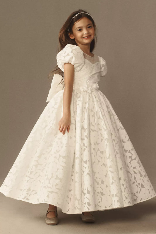 Heowos ivory floral flower girl dress with short puff sleeves, an illusion neckline, fitted bodice and full ankle-length skirt.