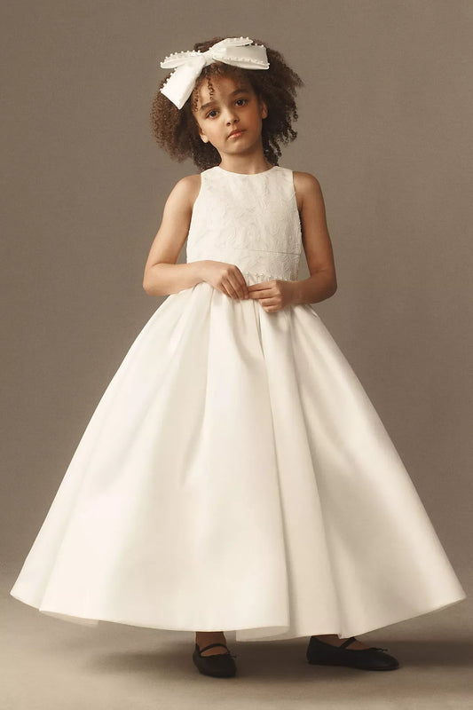 Heowos ivory flower girl ballgown with a floral-textured bodice, round neckline, sleeveless cut and full ankle-length skirt.