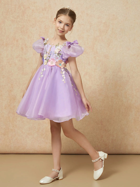 Heowos lavender flower girl dress with pastel floral embroidery, an illusion neckline, bow-topped puff sleeves and an above-knee flared skirt.