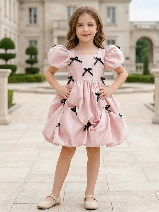 Heowos blush pink flower girl dress with square neck puff sleeves black bows and pick-up skirt