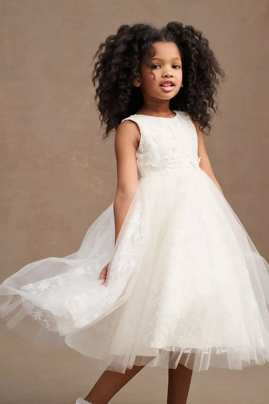 Heowos white flower girl dress with a round neckline, sleeveless floral bodice, pearl-like waist accents and tea-length tulle skirt.