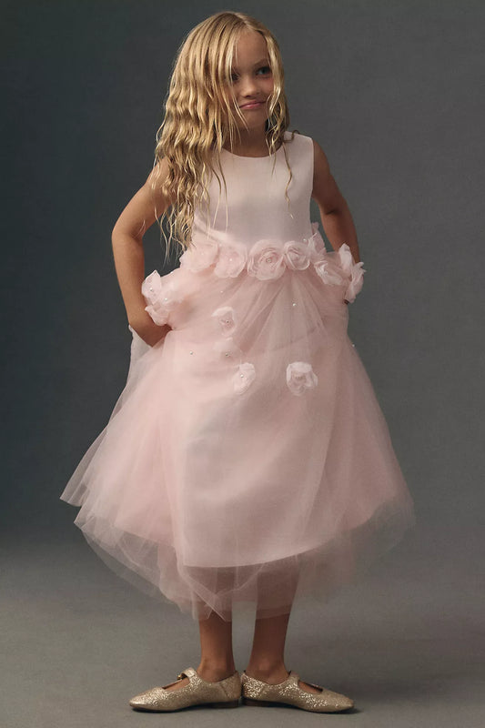 Heowos blush pink flower girl dress with a round neckline, sleeveless bodice, 3D rose waist detail and pearl-like accents on tulle.