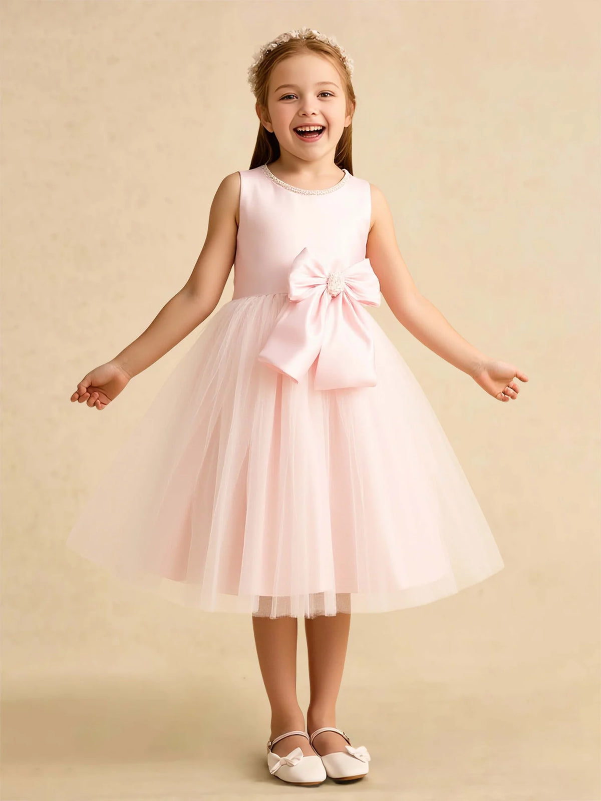 Heowos blush pink flower girl dress with jeweled neckline, large waist bow, and layered tea-length tulle skirt