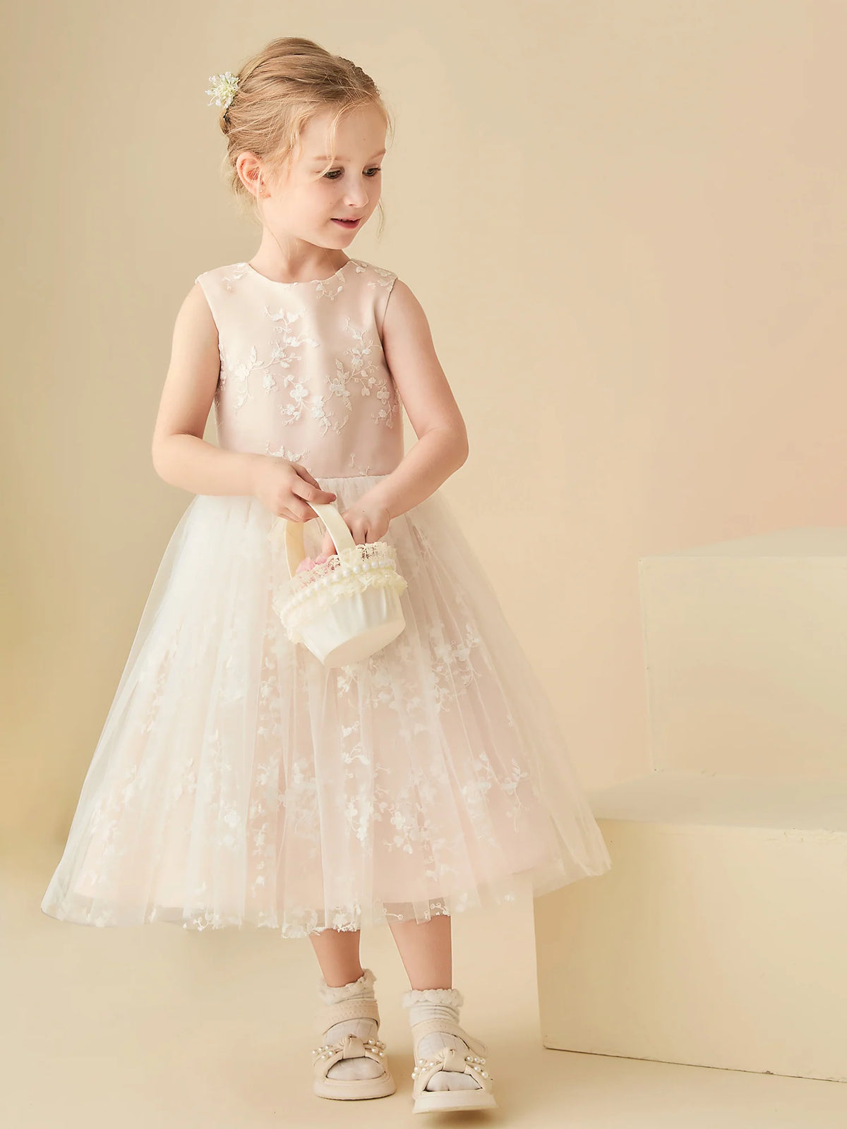 Heowos ivory and champagne flower girl dress with a round neckline, sleeveless embroidered bodice and tea-length floral tulle skirt.