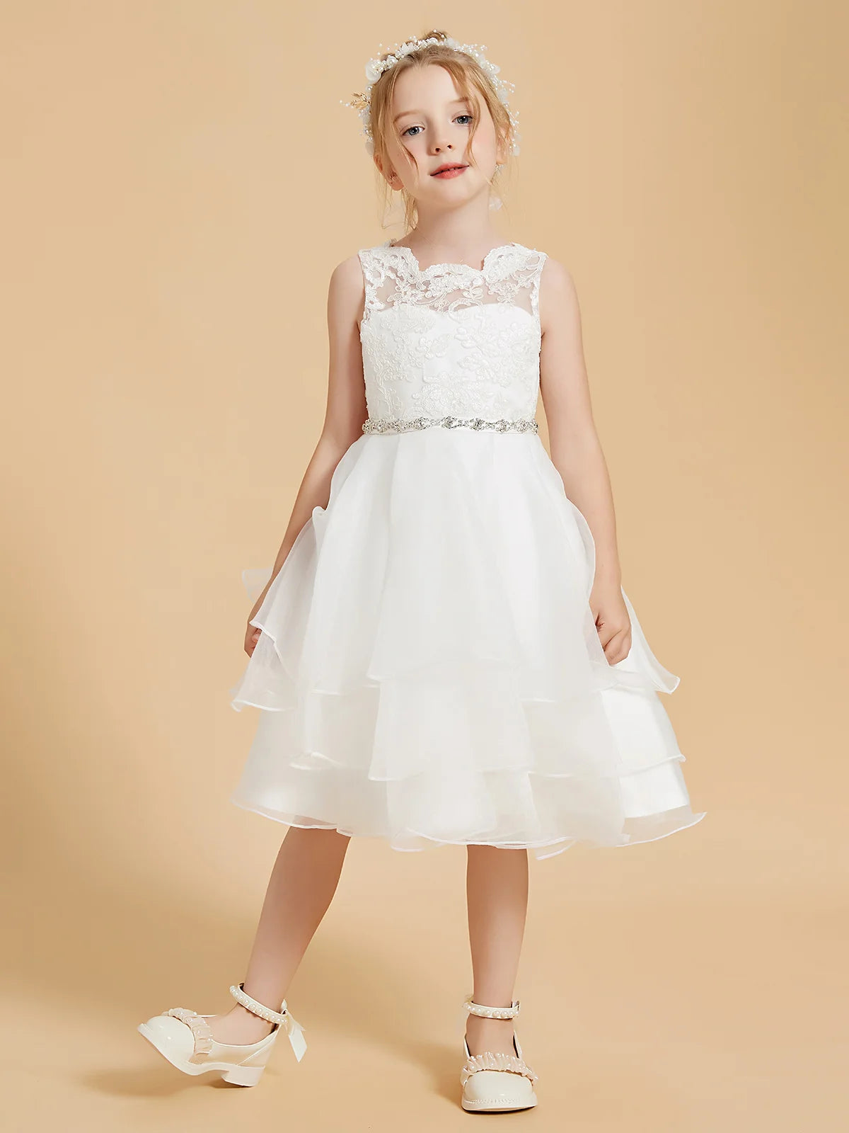 Heowos ivory flower girl dress with scalloped illusion neckline, floral lace bodice, sparkling waistband and tiered skirt.