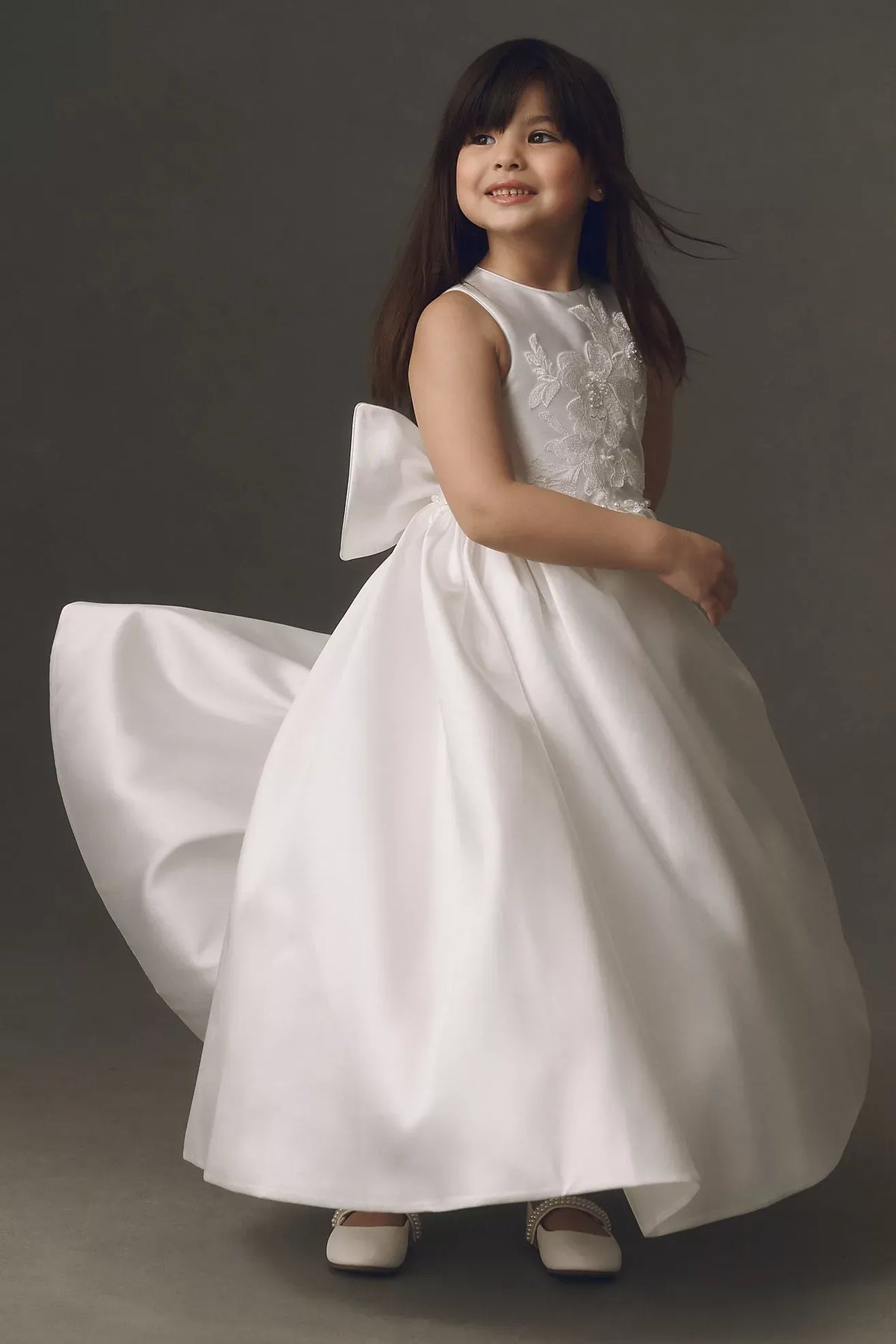 Heowos white first communion dress with a round neckline, sleeveless floral lace bodice, beaded waist and full satin-look skirt.