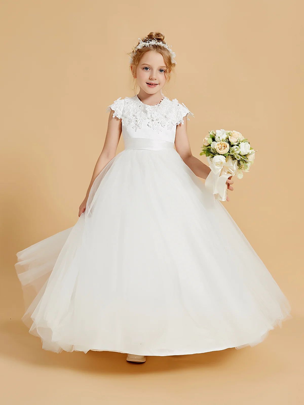 Heowos white Communion dress with round neckline, floral lace cap sleeves, satin waistband and full floor-length tulle skirt.